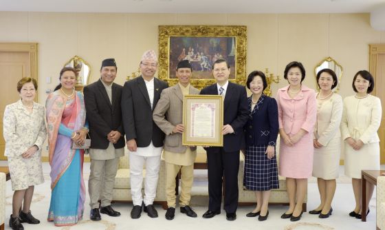 尼泊爾全國專業攝影師協會主席（左5）將證書頒給池田博正主任副會長（右5）